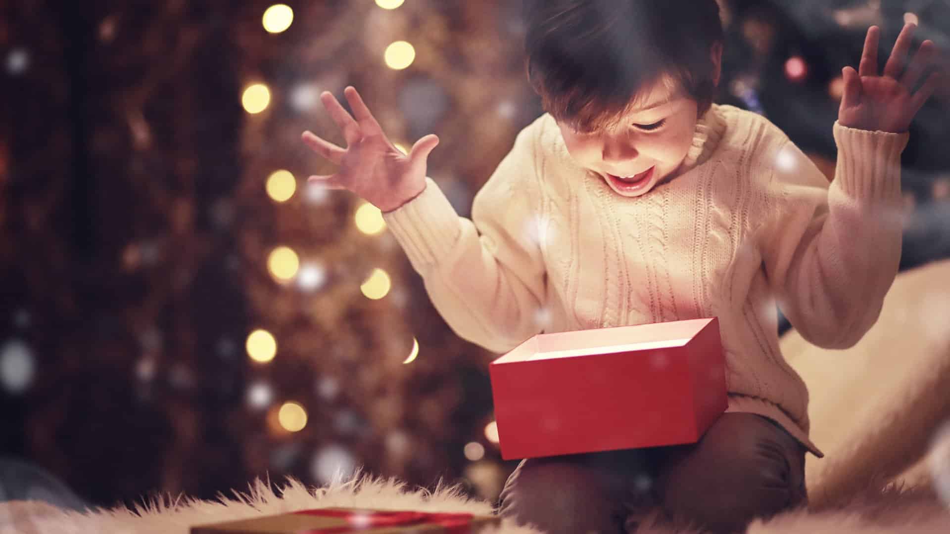 Excited child opening a gift.