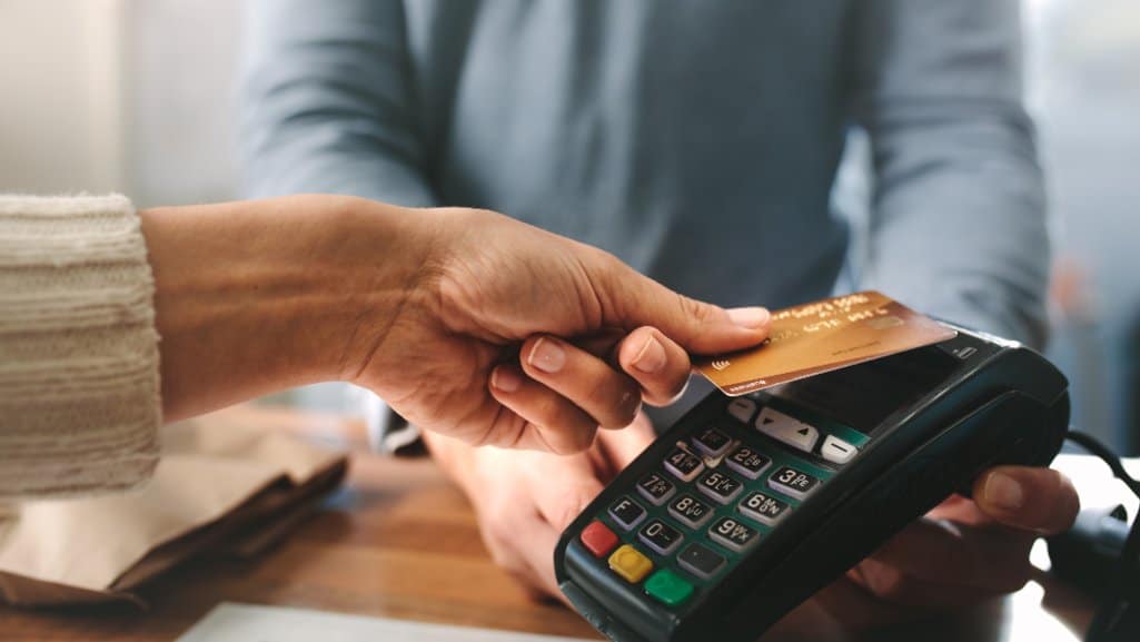 Credit card tapping a PDCU Merchant Services Card Payment Processing.