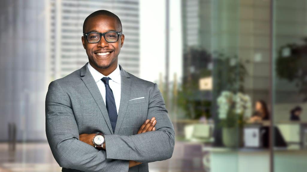 Business owner with a business loan from PDCU standing in his downtown office.