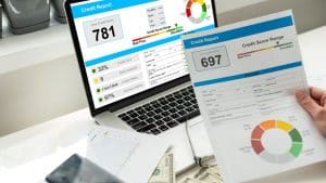 Hand holding a printed credit report that shows a credit score of 697. Credit Counseling mortgage