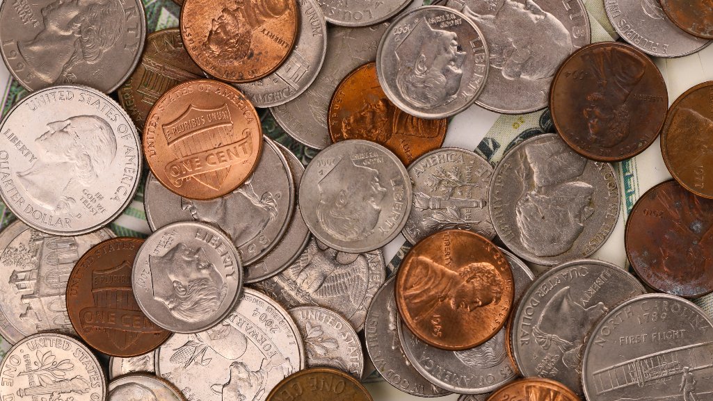 Close-up of mixed U.S. coins, representing People Driven Credit Union’s free coin-counting service for members.