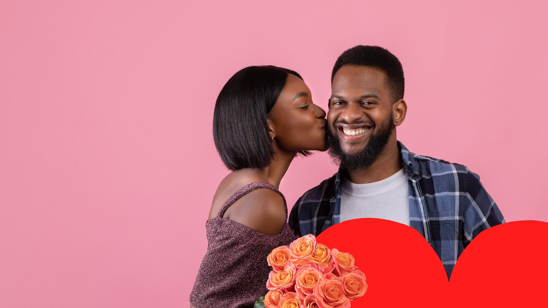 Girlfriend kissing her boyfriend on the cheek while he's holding Valentine's Day flowers.