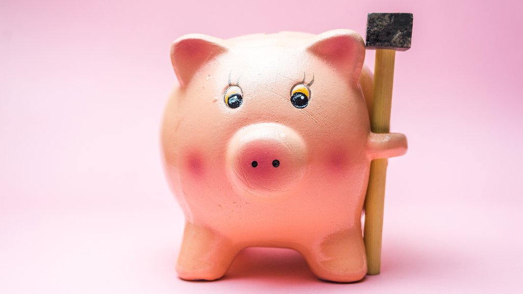 Piggy bank with hammer.