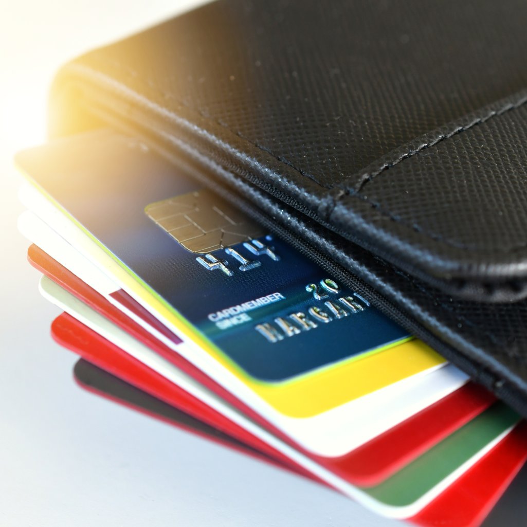 Credit cards with high interest debt sit in a wallet waiting to be consolidated into a debt consolidation loan.