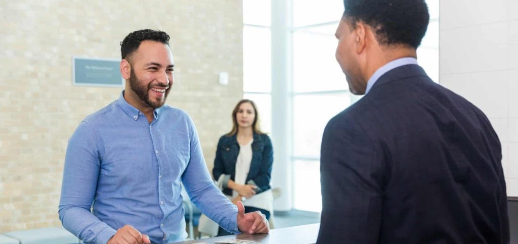 People Driven Credit Union loan officer in Northville talking with a member about a personal loan.