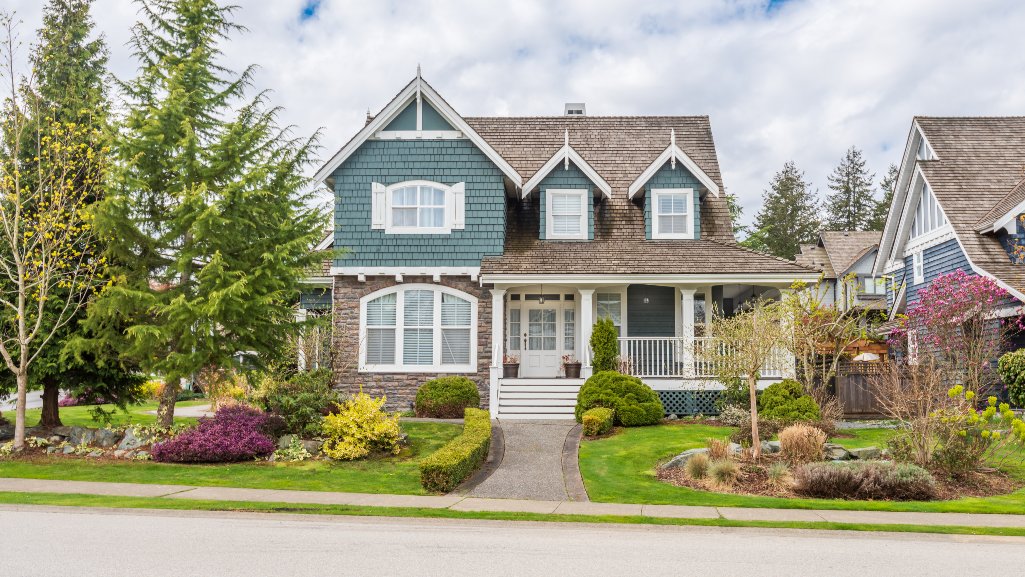 Buying vs. Renting a home with a family standing outside a house.