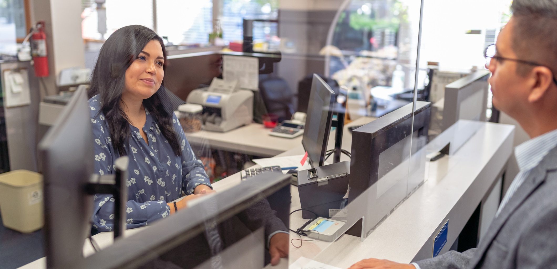 People Driven Credit Union loan officer in Detroit talking with a member about a personal loan.