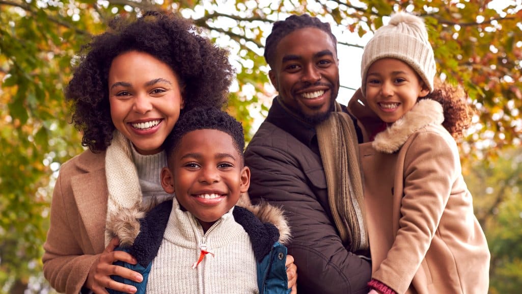 Michigan family of four smiling after overcoming a financial challenge.