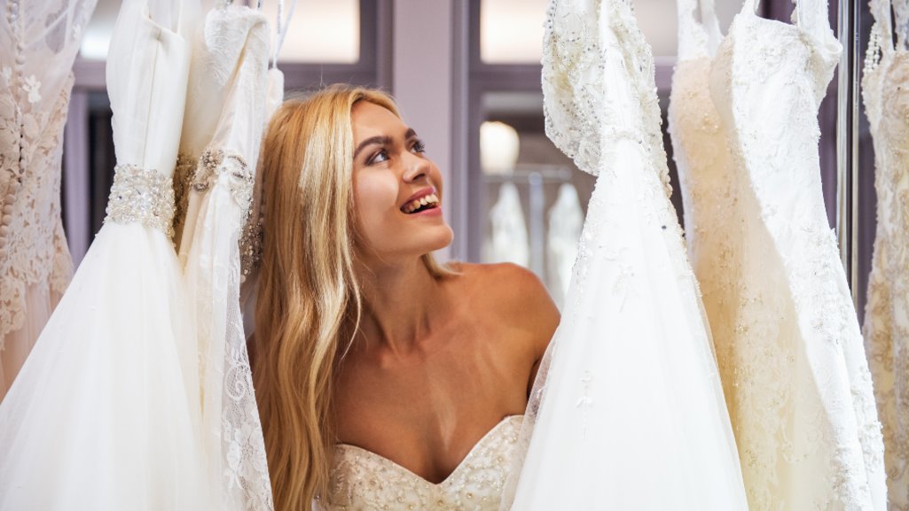 Happy woman is all smiles shopping for her wedding dress after securing a personal loan from People Driven Credit Union.