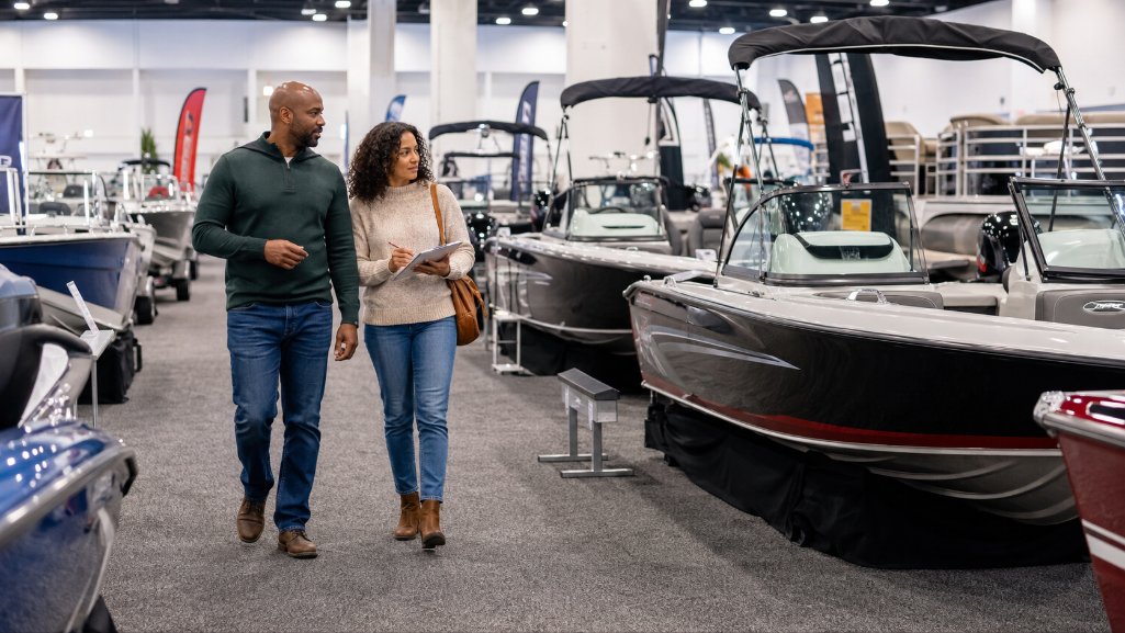 Couple comparison shopping while buying a boat at a boat show.