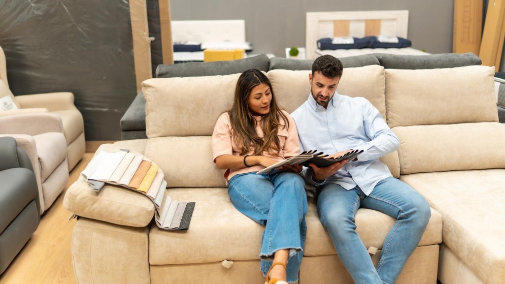 Couple shopping for lease-to-own furniture at a furniture showroom.