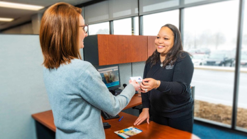 People Driven Credit Union team member helping a member with their banking needs.